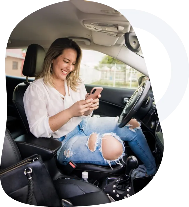 Lady browsing phone in car
